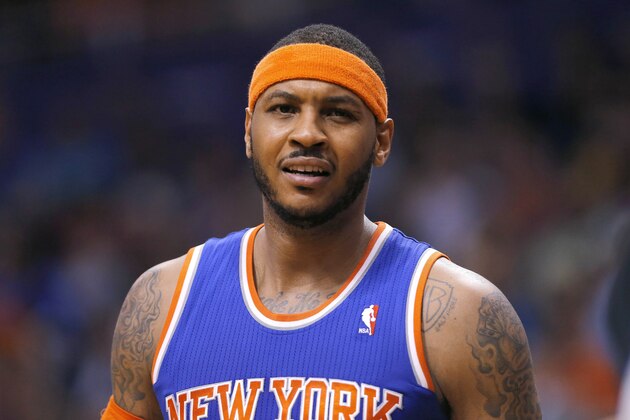 New York Knicks' Carmelo Anthony reacts to an official's call during the second half of an NBA basketball game against the Phoenix Suns, Friday, March 28, 2014, in Phoenix. The Suns won 112-88. (AP Photo/Matt York)