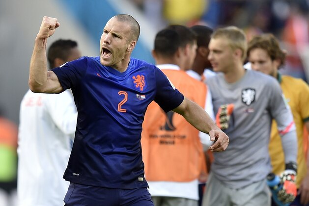 Netherlands' Ron Vlaar celebrates after the group B World Cup soccer match between Australia and the Netherlands at the Estadio Beira-Rio in Porto Alegre, Brazil, Wednesday, June 18, 2014.  The Netherlands won the match 3-2.    (AP Photo/Martin Meissner)