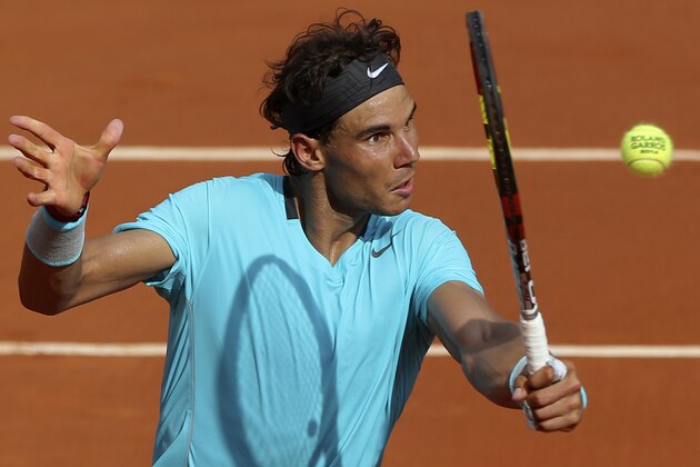 Spain's Rafael Nadal volleys the ball to Serbia's Novak Djokovic during their final match of  the French Open tennis tournament at the Roland Garros stadium, in Paris, France, Sunday, June 8, 2014. (AP Photo/Thibault Camus)