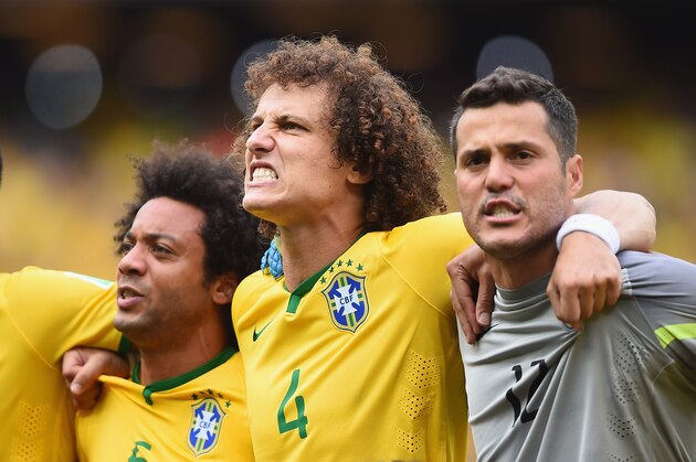 FORTALEZA, BRAZIL - JUNE 17:  David Luiz of Brazil (center) sings the National Anthem with Marcelo and Julio Cesar before the 2014 FIFA World Cup Brazil Group A match between Brazil and Mexico  at Castelao on June 17, 2014 in Fortaleza, Brazil.  (Photo by Laurence Griffiths/Getty Images)