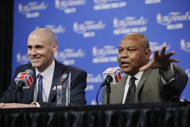 Dallas Mavericks head coach Rick Carlisle smiles as Bernie Bickerstaff, who had just received the 2014 Chuck Daly Lifetime Achievement Award, answers a question before Game 1 of the NBA basketball finals between the San Antonio Spurs and the Miami Heat on Thursday, June 5, 2014, in San Antonio. Bickerstaff is currently an assistant coach with the Cleveland Cavaliers. (AP Photo/Tony Gutierrez)