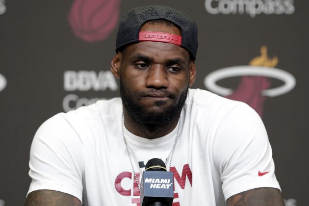 Miami Heat's LeBron James pauses during a news conference in Miami, Tuesday, June 17, 2014. James says he's going on vacation with his family before making any decisions about his future. The Miami Heat held their season-wrap up team meeting on Tuesday afternoon and one of the biggest questions is about the future of the roster. James could become a free agent in a couple of weeks and the four-time MVP says he still has not thought about his plans.(AP Photo/Alan Diaz)