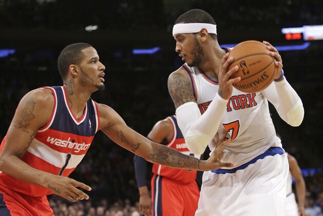 Washington Wizards' Trevor Ariza (1) defends New York Knicks' Carmelo Anthony (7) during the first half of an NBA basketball game Friday, April 4, 2014, in New York. (AP Photo/Frank Franklin II)