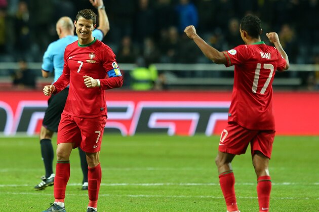 STOCKHOLM, SWEDEN - NOVEMBER 19:  Cristiano Ronaldo (L) of Portugal celebrate with team mate Nani after winning the FIFA 2014 World Cup Qualifier Play-off Second Leg match between Sweden and Portugal at Friends Arena on November 19, 2013 in Stockholm, Sweden.  (Photo by Martin Rose/Getty Images,)