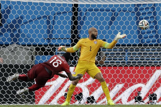 Portugal's Silvestre Varela heads the ball past United States' goalkeeper Tim Howard to score his side's second goal and tie the game 2-2 during the group G World Cup soccer match between the USA and Portugal at the Arena da Amazonia in Manaus, Brazil, Sunday, June 22, 2014. (AP Photo/Martin Mejia)