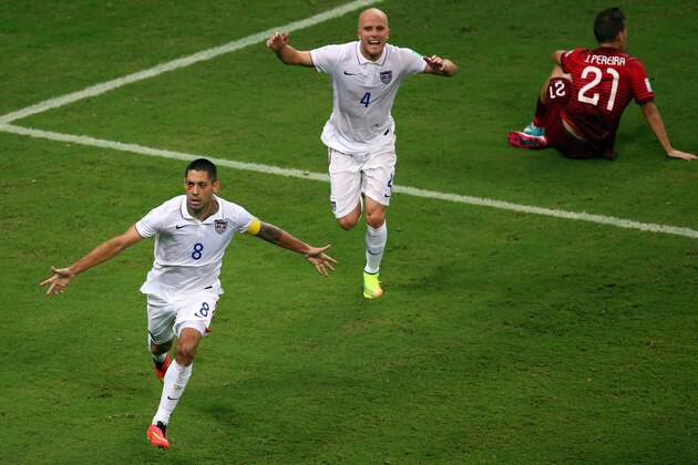 MANAUS, BRAZIL - JUNE 22: Clint Dempsey of the United States celebrates scoring his team's second goal with teammate Michael Bradley as Joao Pereira of Portugal looks on during the 2014 FIFA World Cup Brazil Group G match between the United States and Portugal at Arena Amazonia on June 22, 2014 in Manaus, Brazil.  (Photo by Elsa/Getty Images)
