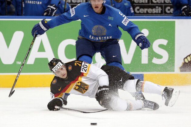 Germany forward Leon Draisaitl, bottom, is challenged by Kazakhstan defender Alexei Litvinenko during the Group B preliminary round match between Germany and Kazakhstan at the Ice Hockey World Championship in Minsk, Belarus, Saturday, May 10, 2014. (AP Photo/Darko Bandic)