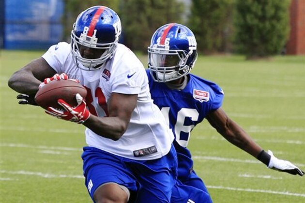New York Giants tight end Adrien Robinson (81), a fourth-round draft pick, catches a pass in front of safety Jojo Nicolas (46) during a drill at the team's NFL football rookie minicamp in East Rutherford, N.J., Friday, May 11, 2012. (AP Photo/Mel Evans)