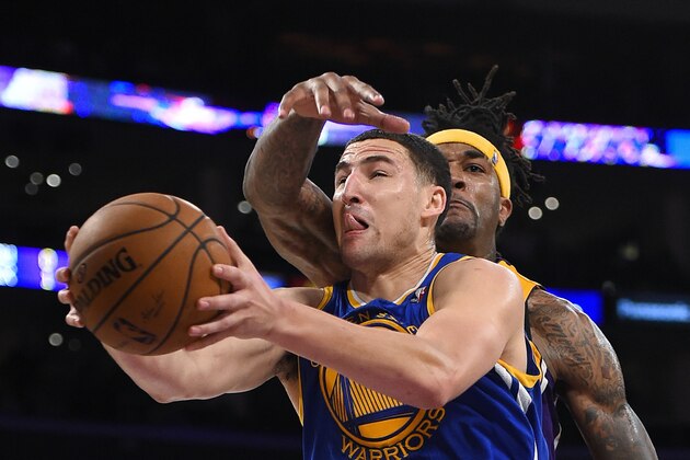 Golden State Warriors guard Klay Thompson goes to the basket as Los Angeles Lakers forward Jordan Hill defends during the second half of an NBA basketball game, Friday, April 11, 2014, in Los Angeles. The Warriors won 112-95. (AP Photo/Mark J. Terrill)