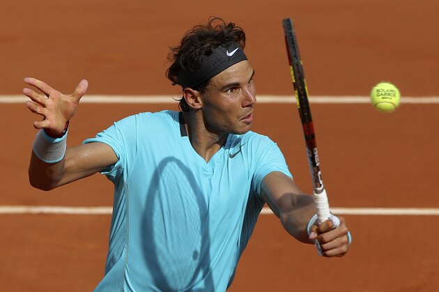 Spain's Rafael Nadal volleys the ball to Serbia's Novak Djokovic during their final match of  the French Open tennis tournament at the Roland Garros stadium, in Paris, France, Sunday, June 8, 2014. (AP Photo/Thibault Camus)