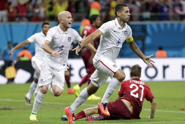 United States' Clint Dempsey (8) celebrates with teammate Michael Bradley after scoring his side's second goal during the group G World Cup soccer match between the United States and Portugal at the Arena da Amazonia in Manaus, Brazil, Sunday, June 22, 2014. (AP Photo/Julio Cortez)