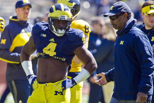 Michigan linebacker Cameron Gordon (4) get feedback from running backs coach Fred Jackson, right, during the NCAA college football team's annual spring game on Saturday, April 5, 2014, in Ann Arbor, Mich. (AP Photo/Tony Ding)