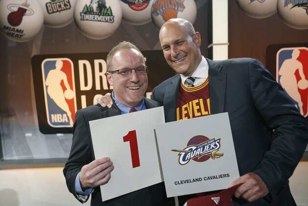 Cleveland Cavaliers general manager David Griffin, left, and minority owner Jeff Cohen celebrate after the Cavaliers won the top pick in the the NBA basketball draft lottery in New York, Tuesday, May 20, 2014. It's the third time in four years the Cavs will be atop the draft after moving up from the ninth spot. (AP Photo/Kathy Willens)