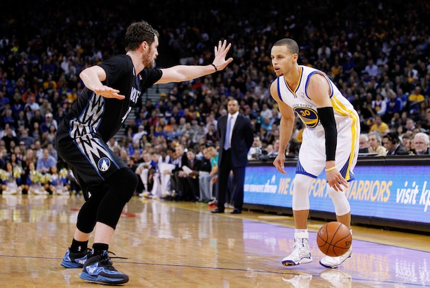 Jan 24, 2014; Oakland, CA, USA; Golden State Warriors guard Stephen Curry (30) is defended by Minnesota Timberwolves forward Kevin Love (42) in the fourth quarter at Oracle Arena. The Timberwolves defeated the Warriors 121-120. Mandatory Credit: Cary Edmondson-USA TODAY Sports