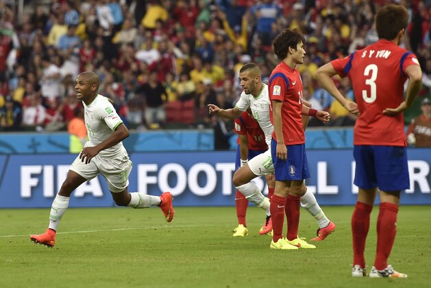 Algeria's Yacine Brahimi, left, celebrates after scoring his side's fourth goal during the group H World Cup soccer match between South Korea and Algeria at the Estadio Beira-Rio in Porto Alegre, Brazil, Sunday, June 22, 2014. (AP Photo/Martin Meissner)