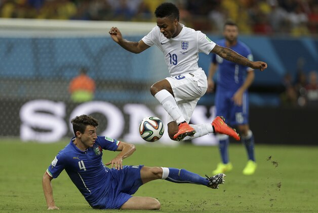 England's Raheem Sterling, top, is challenged by Italy's Matteo Darmian during the group D World Cup soccer match between England and Italy at the Arena da Amazonia in Manaus, Brazil, Saturday, June 14, 2014. (AP Photo/Martin Mejia)