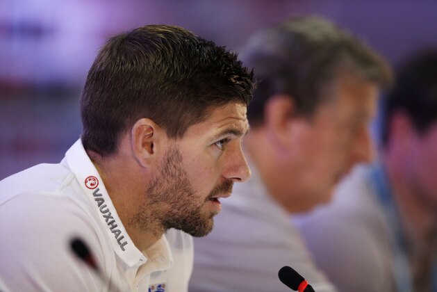 England national soccer team captain Steven Gerrard, left, speaks flanked by head coach Roy Hodgson, right, during a press conference after a squad training session that was closed to the media for the 2014 soccer World Cup at the Urca military base in Rio de Janeiro, Brazil, Sunday, June 22, 2014.  Costa Rica's surprise 1-0 win over Italy on Friday meant that England made its most humiliating exit from a World Cup since 1958, following consecutive defeats by the Italians and then Uruguay in Group D.  England play Costa Rica in their final Group D match on Tuesday.  (AP Photo/Matt Dunham)