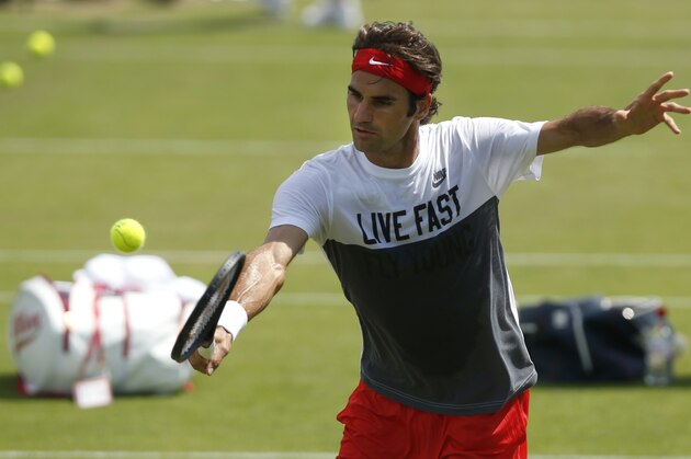 Roger Federer of Switzerland plays a shot  during a practice session ahead of the All England Lawn Tennis Championships in Wimbledon, London,  Sunday June  22, 2014. The Championships start Monday June 23. (AP Photo/Sang Tan)