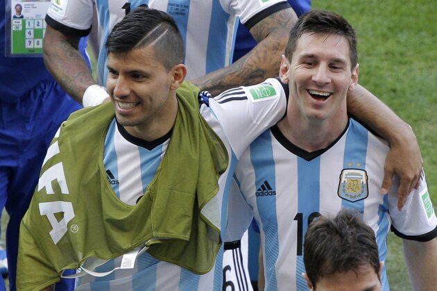 Argentina's Lionel Messi jokes, right, with Argentina's Sergio Aguero as he leaves the pitch after the group F World Cup soccer match between Argentina and Iran at the Mineirao Stadium in Belo Horizonte, Brazil, Saturday, June 21, 2014. Lionel Messi scored a superb goal in stoppage time to give Argentina a 1-0 victory over Iran.(AP Photo/Sergei Grits)