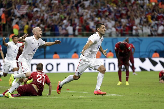 United States' Clint Dempsey (8) celebrates with teammate Michael Bradley after scoring his side's second goal during the group G World Cup soccer match between the United States and Portugal at the Arena da Amazonia in Manaus, Brazil, Sunday, June 22, 2014. (AP Photo/Julio Cortez)