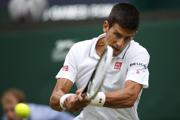 Novak Djokovic of Serbia plays a return to Andrey Golubev of Kazakhstan during their first round match at the All England Lawn Tennis Championships in Wimbledon, London,  Monday, June  23, 2014. (AP Photo/Pavel Golovkin)
