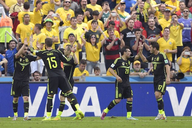 Spain's David Villa, left, celebrates with teammate Spain's Sergio Ramos after scoring during the group B World Cup soccer match between Australia and Spain at the Arena da Baixada in Curitiba, Brazil, Monday, June 23, 2014. At right Spain's Santi Cazorla and Spain's Koke, right.(AP Photo/Manu Fernandez)