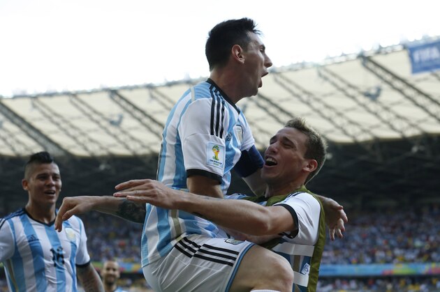 Argentina's Lionel Messi, second right, celebrates after scoring the first goal during the group F World Cup soccer match between Argentina and Iran at the Mineirao Stadium in Belo Horizonte, Brazil, Saturday, June 21, 2014. Argentina won 1-0.  (AP Photo/Jon Super)