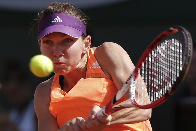 Romania's Simona Halep returns the ball during final of the French Open tennis tournament against Russia's Maria Sharapova at the Roland Garros stadium, in Paris, France, Saturday, June 7, 2014. (AP Photo/Michel Euler)