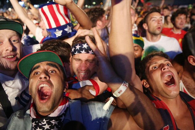 RIO DE JANEIRO, BRAZIL - JUNE 22:  American fans celebrate after the U.S. scored to take a 2-1 lead over Portugal while watching a video broadcast at the FIFA Fan Fest on Copacabana Beach during the 2014 FIFA World Cup Brazil on June 22, 2014 in Rio de Janeiro, Brazil. The game ended in a 2-2 tie.  (Photo by Mario Tama/Getty Images)