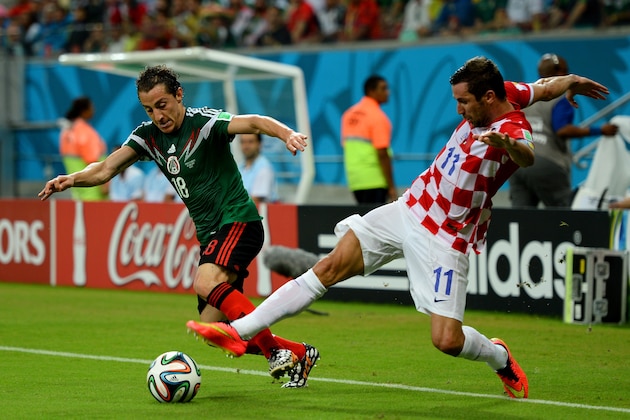 RECIFE, BRAZIL - JUNE 23:  Andres Guardado of Mexico and Darijo Srna of Croatia compete for the ball during the 2014 FIFA World Cup Brazil Group A match between Croatia and Mexico at Arena Pernambuco on June 23, 2014 in Recife, Brazil.  (Photo by Jamie McDonald/Getty Images)