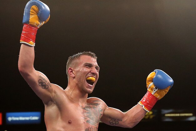 LOS ANGELES, CA - JUNE 21:  Vasyl Lomachenko celebrates after the final bell against Gary Russell Jr. in their WBO Featherwieight Title bout at StubHub Center on June 21, 2014 in Los Angeles, California.  Lomachenko won by split decision.  (Photo by Stephen Dunn/Getty Images)