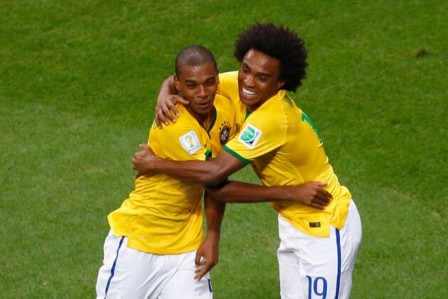 BRASILIA, BRAZIL - JUNE 23: Fernandinho of Brazil (L) celebrates scoring his team's fourth goal with Willian during the 2014 FIFA World Cup Brazil Group A match between Cameroon and Brazil at Estadio Nacional on June 23, 2014 in Brasilia, Brazil.  (Photo by Phil Walter/Getty Images)