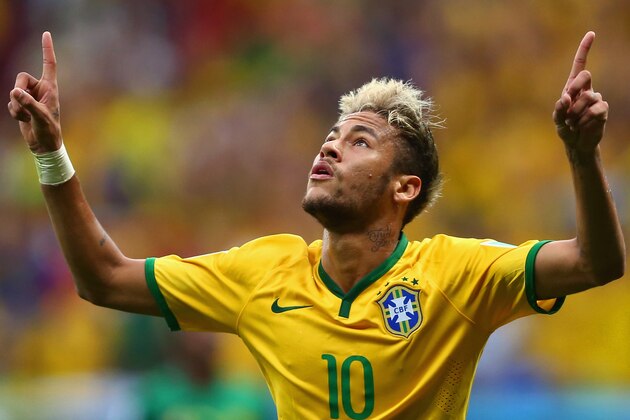 BRASILIA, BRAZIL - JUNE 23:  Neymar of Brazil celebrates scoring his team's second goal and his second of the game during the 2014 FIFA World Cup Brazil Group A match between Cameroon and Brazil at Estadio Nacional on June 23, 2014 in Brasilia, Brazil.  (Photo by Clive Brunskill/Getty Images)