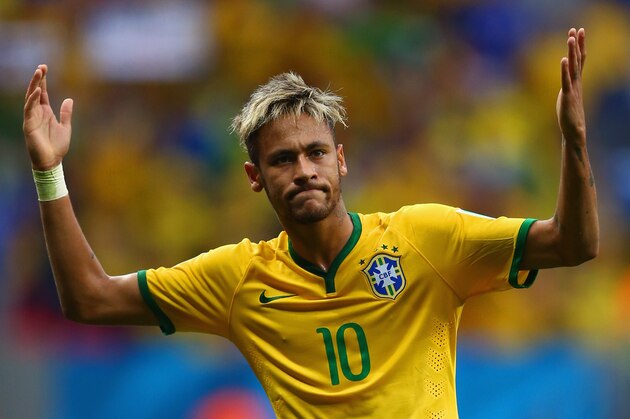 BRASILIA, BRAZIL - JUNE 23: Neymar of Brazil celebrates scoring his team's second goal and his second of the game during the 2014 FIFA World Cup Brazil Group A match between Cameroon and Brazil at Estadio Nacional on June 23, 2014 in Brasilia, Brazil.  (Photo by Clive Brunskill/Getty Images)