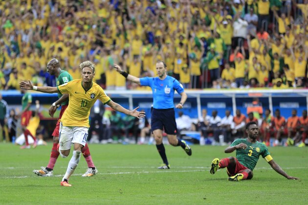 Brazil's Neymar celebrates after scoring his side's second goal during the group A World Cup soccer match between Cameroon and Brazil at the Estadio Nacional in Brasilia, Brazil, Monday, June 23, 2014. (AP Photo/Bernat Armangue)