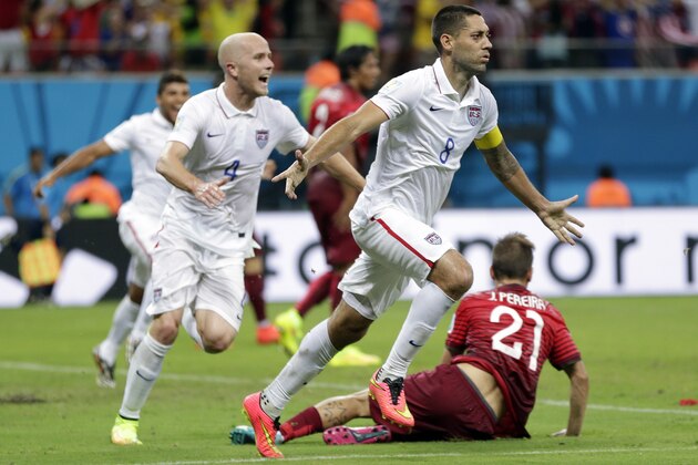 United States' Clint Dempsey (8) celebrates with teammate Michael Bradley after scoring his side's second goal during the group G World Cup soccer match between the United States and Portugal at the Arena da Amazonia in Manaus, Brazil, Sunday, June 22, 2014. (AP Photo/Julio Cortez)