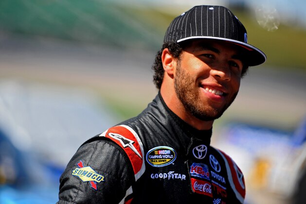 KANSAS CITY, KS - MAY 09: Darrell Wallace Jr., driver of the #54 Toyota Time Sales Event Toyota, stands on the grid during qualifying for the NASCAR Camping World Truck Series SFP 250 at Kansas Speedway on May 9, 2014 in Kansas City, Kansas.  (Photo by Will Schneekloth/Getty Images)