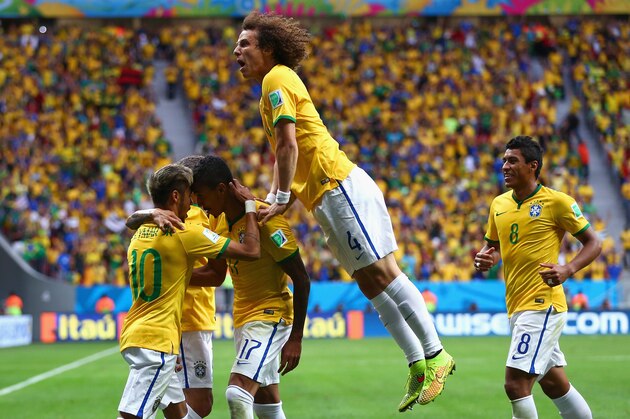 BRASILIA, BRAZIL - JUNE 23:  Neymar of Brazil (L) celebrates scoring his team's first goal with Luiz Gustavo and David Luiz of Brazil during the 2014 FIFA World Cup Brazil Group A match between Cameroon and Brazil at Estadio Nacional on June 23, 2014 in Brasilia, Brazil.  (Photo by Clive Brunskill/Getty Images)