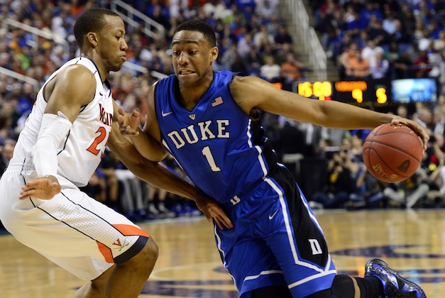 Mar 16, 2014; Greensboro, NC, USA; Duke Blue Devils forward Jabari Parker (1) moves the ball up the court against Virginia Cavaliers forward Akil Mitchell (25) in the championship game of the ACC college basketball tournament at Greensboro Coliseum. Mandatory Credit: John David Mercer-USA TODAY Sports