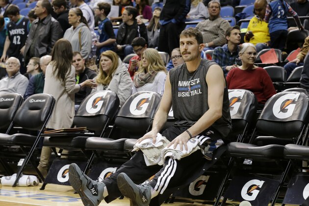 Minnesota Timberwolves forward Kevin Love sits on the bench with ice on his knees before an NBA basketball game against the Utah Jazz in Minneapolis, Wednesday, April 16, 2014. (AP Photo/Ann Heisenfelt)