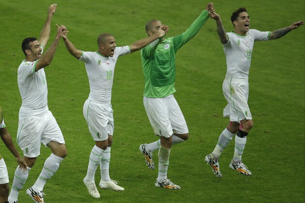 Members of the Algerian soccer team join hands as they celebrate after winning 4-2, the group H World Cup soccer match between South Korea and Algeria at the Estadio Beira-Rio in Porto Alegre, Brazil, Sunday, June 22, 2014. (AP Photo/Michael Sohn)