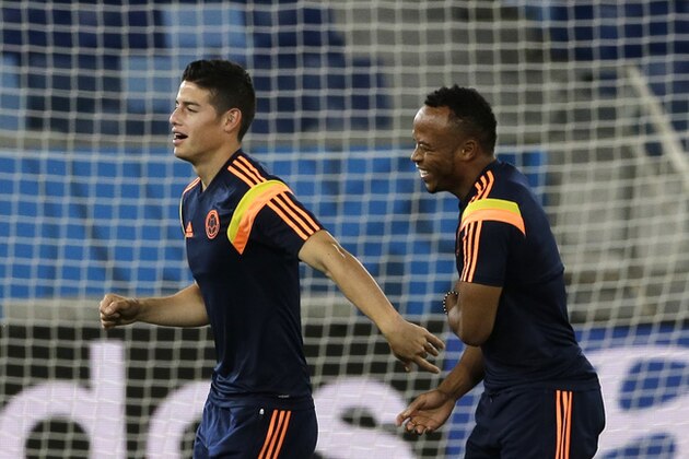 Colombia's James Rodriguez, left, and Juan Zuniga warm up during a training session of Colombia at Arena Pantanal in Cuiaba, Brazil, Monday, June 23, 2014.  Colombia play in group C of the 2014 soccer World Cup. (AP Photo/Shuji Kajiyama)