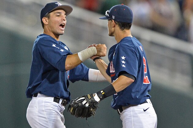 Omaha, NE - JUNE 23:  Players Vince Conde (L) and Tyler Campbell (R) of the Vanderbilt Commodores celebrate after beating the Virginia Cavaliers 9-8 during game one of the College World Series Championship on June 23, 2014 at TD Ameritrade Park in Omaha, Nebraska. (Photo by Peter Aiken/Getty Images)