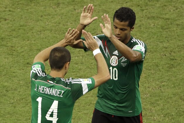 Mexico's Javier Hernandez (14) comes into the game for Mexico's Giovani dos Santos (10) during the group A World Cup soccer match between Croatia and Mexico at the Arena Pernambuco in Recife, Brazil, Monday, June 23, 2014. (AP Photo/Hassan Ammar)