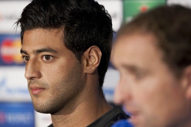 Real Sociedad's Carlos Vela, left, sits alongside coach Jagoba Arrasate during a press conference at Manchester United's Old Trafford Stadium, Manchester, England, Tuesday, Oct. 22, 2013. Real Sociedad will play  Manchester United in a Champion's League Group A soccer match on Wednesday. (AP Photo/Jon Super)