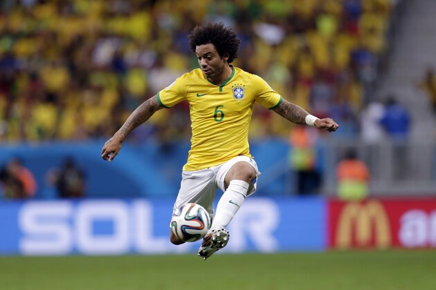 Brazil's Marcelo controls a ball during the group A World Cup soccer match between Cameroon and Brazil at the Estadio Nacional in Brasilia, Brazil, Monday, June 23, 2014. (AP Photo/Dolores Ochoa)