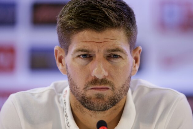 England national soccer team captain Steven Gerrard listens as head coach Roy Hodgson speaks during a press conference after a squad training session that was closed to the media for the 2014 soccer World Cup at the Urca military base in Rio de Janeiro, Brazil, Sunday, June 22, 2014.  Costa Rica's surprise 1-0 win over Italy on Friday meant that England made its most humiliating exit from a World Cup since 1958, following consecutive defeats by the Italians and then Uruguay in Group D.  England play Costa Rica in their final Group D match on Tuesday.  (AP Photo/Matt Dunham)