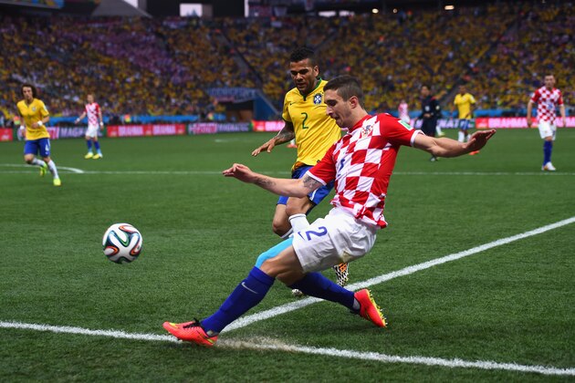 SAO PAULO, BRAZIL - JUNE 12: Sime Vrsaljko of Croatia tries to keep the ball inbounds against Dani Alves of Brazil in the first half during the 2014 FIFA World Cup Brazil Group A match between Brazil and Croatia at Arena de Sao Paulo on June 12, 2014 in Sao Paulo, Brazil.  (Photo by Christopher Lee/Getty Images)