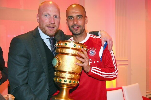 In this picture taken  Saturday May 17, 2014, Bayern Munich's coach Pep Guardiola, right, holds the German soccer cup with sporting director  Matthias Sammer during the after-match party after the club won the German soccer cup final  against Borussia Dortmund in Berlin. (AP Photo/ Alexander Hassenstein,Pool)