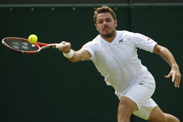 Stan Wawrinka of Switzerland plays a return to Joao Sousa of Portugal during their first round match at the All England Lawn Tennis Championships in Wimbledon, London, Tuesday, June 24, 2014. (AP Photo/Alastair Grant)